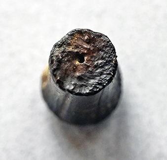 The .40 caliber bullet base showing clearly the impressions from impacting powder grains.